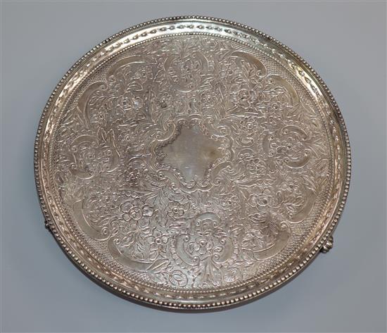 A George III silver salver, by Crouch & Hannam, London, 1777, with later embossed decoration, on three scroll feet, 13.5 oz.